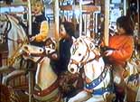 Image of 
Lila, Rebecca and Regina on the Merry-Go-Round